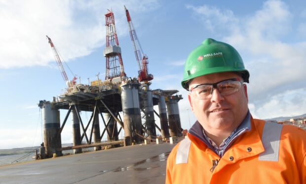 Well-Safe chief executive Phil Milton at Global Energy Park at Nigg with the Well-Safe Guardian rig in the background.