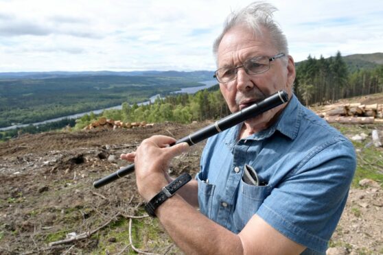 Larry Smith playing his Celtic pipe, part of his missing luggage