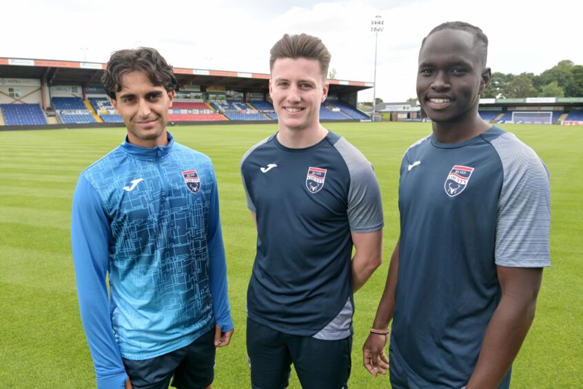 Ross county players smiling at the camera.