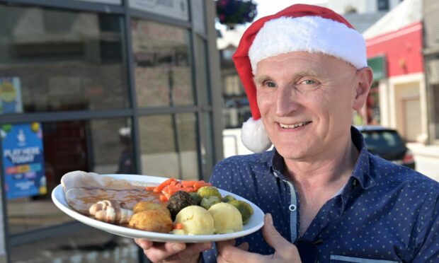Charlie's Cafe owner, Martin Pieraccini, unveils the latest menu item, Christmas Dinner in June.