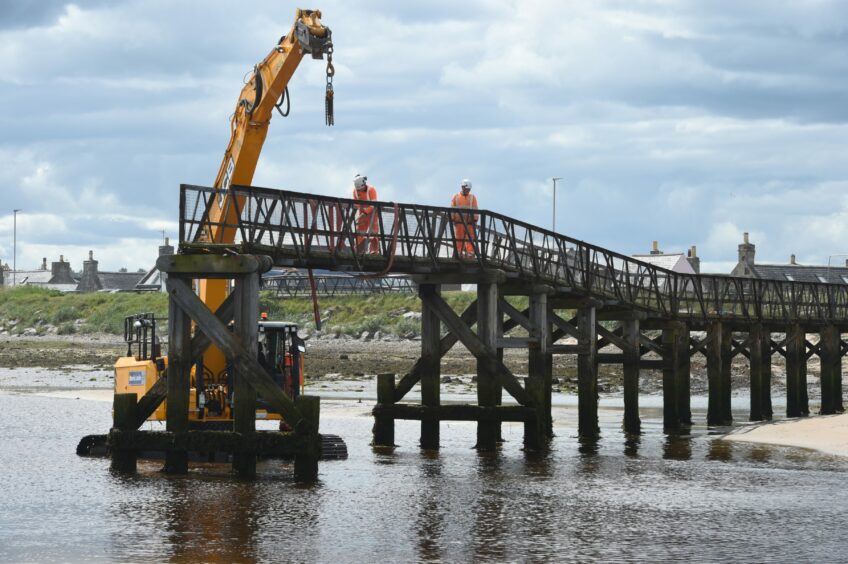 Workers on the Lossiemouth bridge during the deconstruction process
