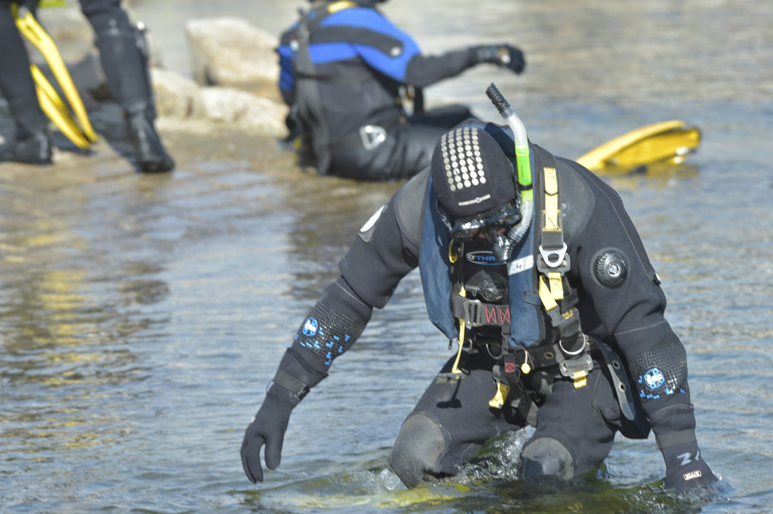Police divers in the water.