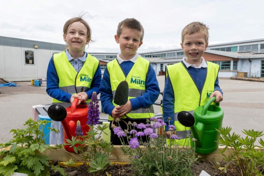 Budding gardeners: The pupils are loving their new watering cans.