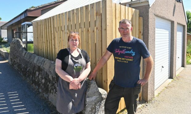 Kemnay Farm Shop owners Michelle and Steven Clark stand next to the fencing that surrounds the chiller unit. Image: Scott Baxter/DC Thomson