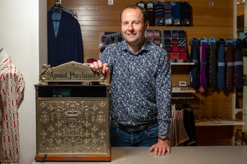 Mark with the store's vintage style cash register.