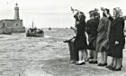 Fishermen's wives wave the fleet off from Fraserburgh in 1949.