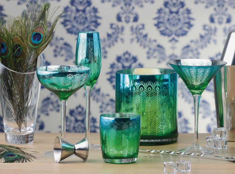 A collection of fancy, peacock-themed glassware.