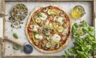 Vegetable pizza with toppers and sprouts.