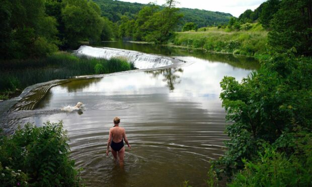 Time for a swim at Warleigh Weir on the Kennet and Avon canal near Bath. Ben Birchall/PA Wire