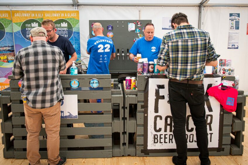 Customers purchasing beer from the bar at the Midsummer Beer Festival