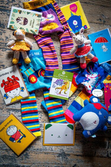A selection of children's products including cards, clothes and toys.