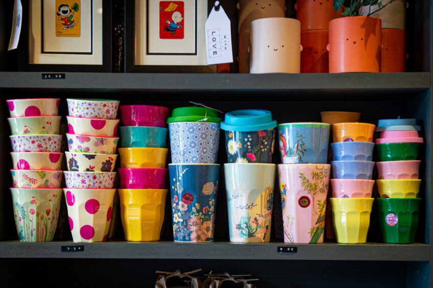 A selection of colourful to-go cups and ceramic cups.