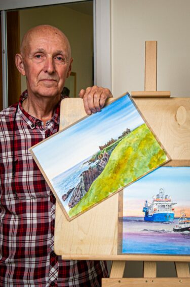 Gordon McLeman with two watercolour paintings