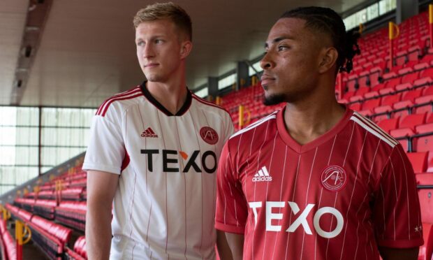 Ross McCrorie models Aberdeen's new away kit, while Vicente Besuijen wears the new home strip.