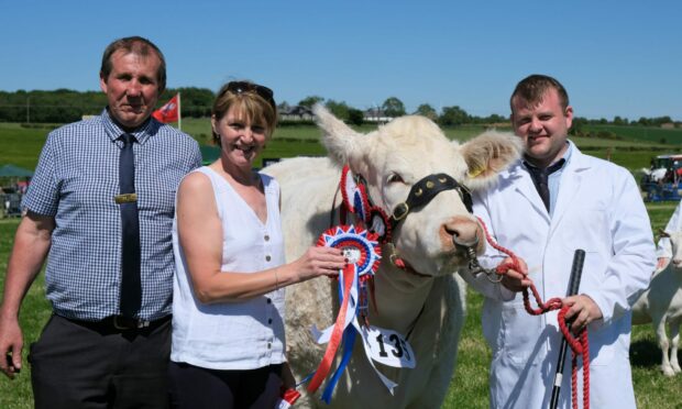 REWARDING: Show chairman Russell Wood and his wife Jackie preent the champion of champions award to Jamie Rettie who brought out the winner for Brailes Livestock.