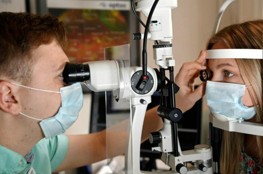 Optometrist and a patient during eye test.