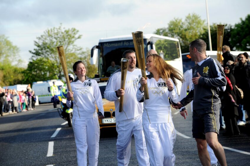 five BP employees, Sarah Marriott, Mehment Tanilir, Claire-Lise Honsinger, Lindsay Rennie and Craig Donaldson carry the Olympic torch in 2012.