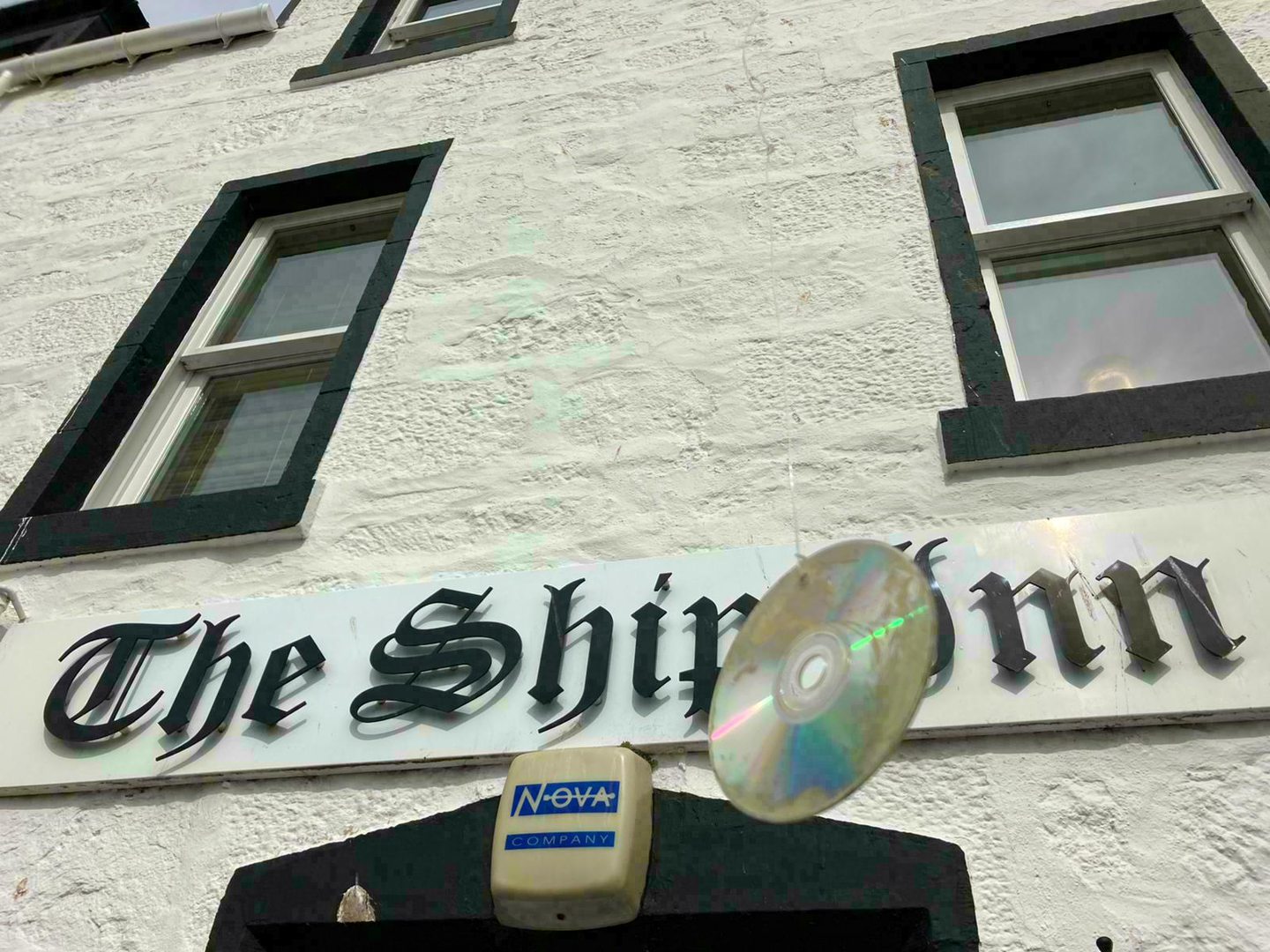 A CD dangling over the front of the Ship Inn sign.