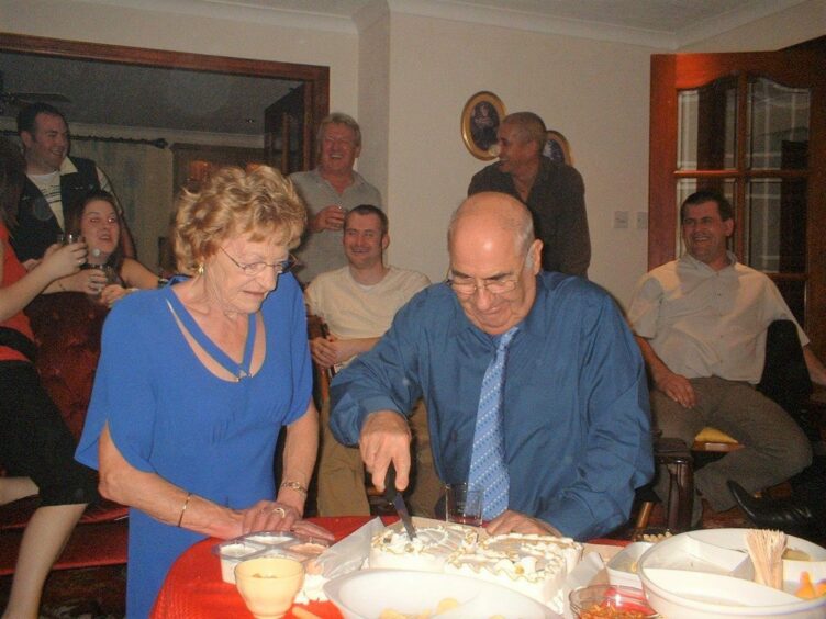 Former Turriff postman Harry Duncan shown with wife Nan cutting the cake at their 50th wedding anniversary.