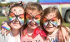 Young girls in rainbow butterfly face apint