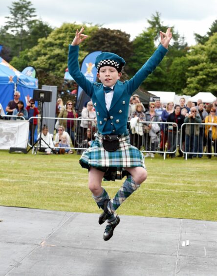 Moby Knight Highland dancing in full traditional attire at the Aberdeen Highland Games