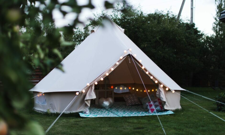Canvas cotton Bell tent in the yard decorated for summer kids party;
