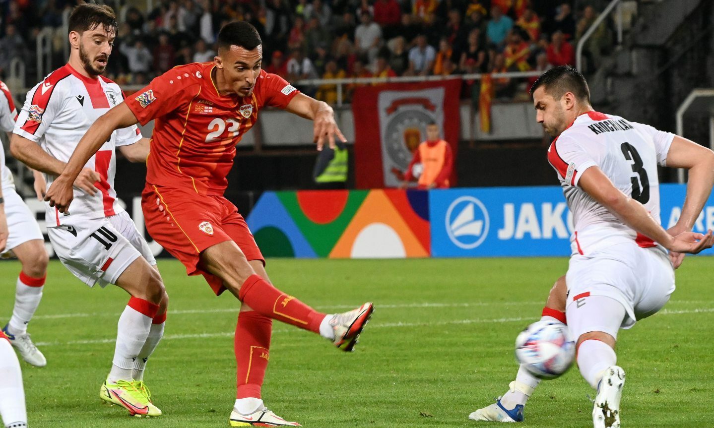 Georgia's David Khocholava (R) in action against North Macedonia's Bojan Miovski (C) during the UEFA Nations League match.