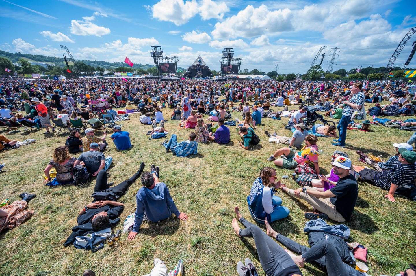 Music fans at Glastonbury relax in the sun.