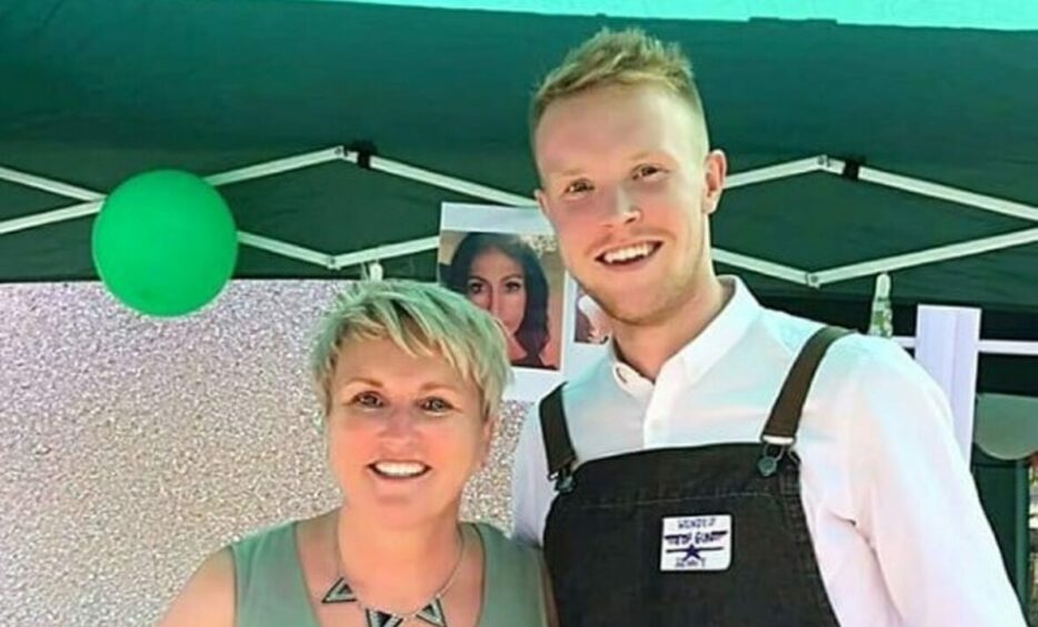 Tracy and her son smiling at the camera together