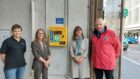 Pam Gowie, lead instructor from Lucky2BHere; Provost of Inverness, Glynis Sinclair; Jo Murray, manager of Inverness Victorian market and John Mcdonald, community safety manager for Inverness Bid unveiled the new defibrillator outside the Queensgate entrance of the Inverness Victorian Market.