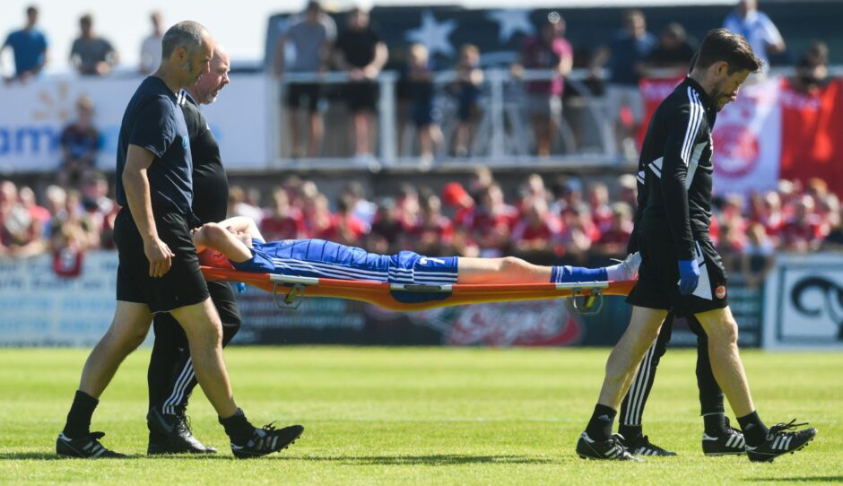 Peterhead midfielder Hamish Ritchie is stretchered off