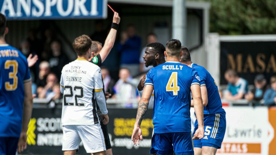 Livingston's Esmael Goncalves is shown a red card