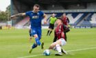 Cove Rangers' Scott Ross and Caley Thistle's Daniel Mackay fight for the ball in a Premier Sports Cup match.