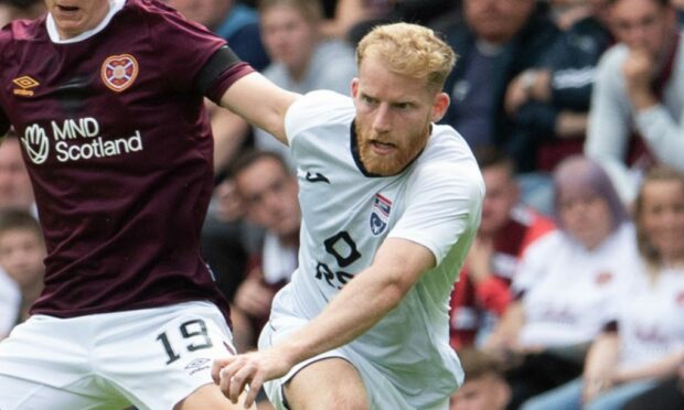 Josh SIms in action for Ross County against Hearts.