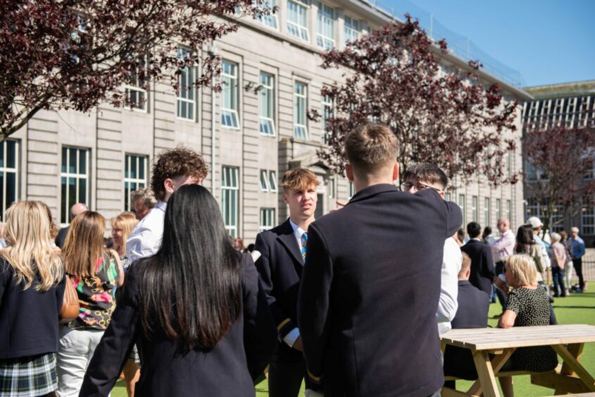 Students on the Robert Gordon's College grounds in the sun.