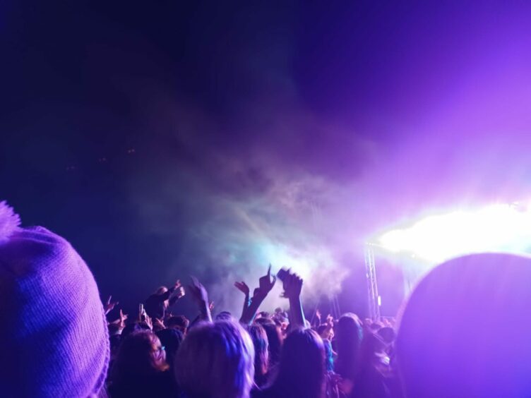 A festival crowd with a haze of smoke.