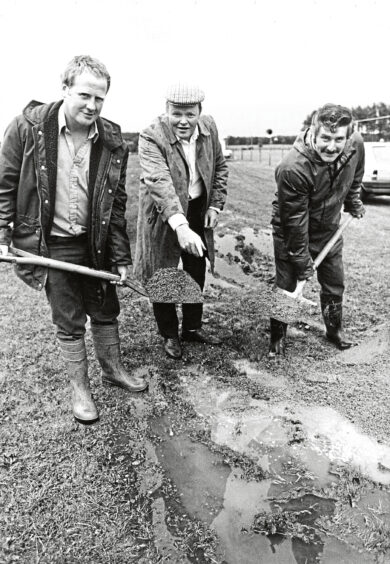 Men shoveling the showground for the Echt show.