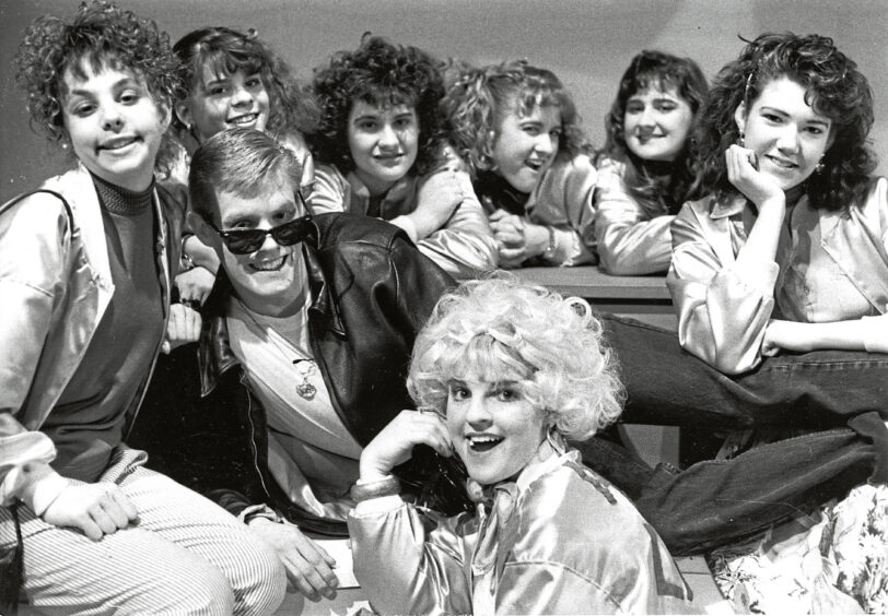 April 1989 - 1989 - Casey Schneider stars as Danny in Grease at the Aberdeen Arts Centre , flanked by Courtney Shaw, Andrea Robert, Kim Norwood, Kristy Hood, Kayla Hood, Shelley McClellan, amd Diane Jensson