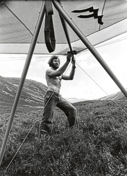 A man dismantling his hang glider