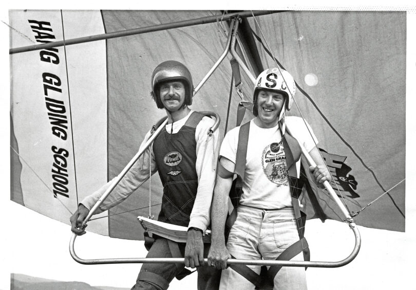 Two men preparing to be hang gliding