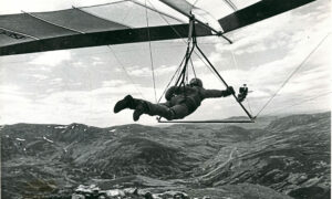 A man hang gliding in the air