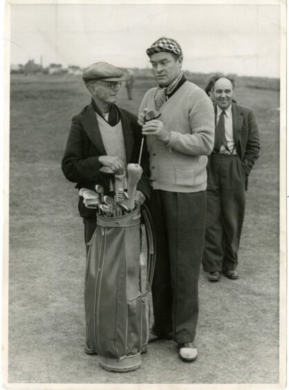 Bob Hope clowning with a caddy at Carnoustie in 1952