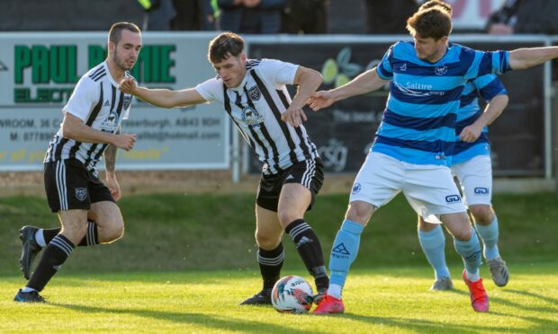 Ryan Sargent, centre, of Fraserburgh tries to hold off Banks o' Dee's Darryn Kelly, right