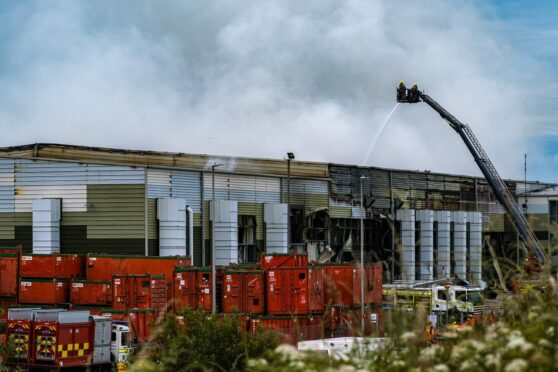 Firefighters are using a height appliance to dampen down the fire at Altens recycling centre. Picture: Gabor Bartfai