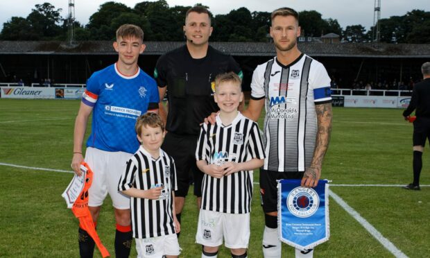 Brian Cameron with his daughter Sophie and son Fraser and Rangers' Robbie Fraser ahead of his testimonial kick-off against Rangers B. Picture - Bob Crombie