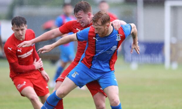 Caley Thistle's David Carson keeps the ball under pressure.