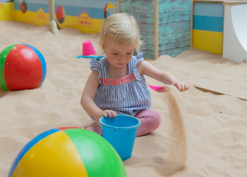 Toddler playing with sand in Bon Accord (things to do in Aberdeen with kids this summer)