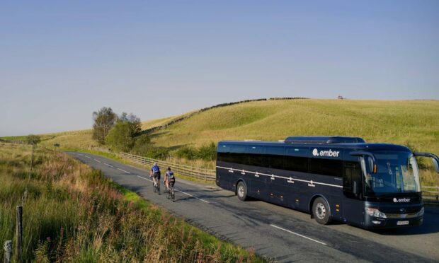 Ember bus with two passing cyclists.