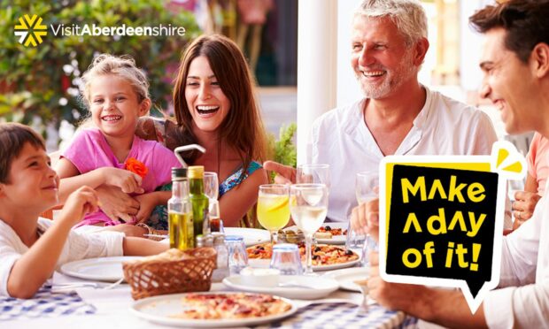 Family eating together. VisitAberdeenshire wants you to enjoy outdoor dining in Aberdeenshire this summer.