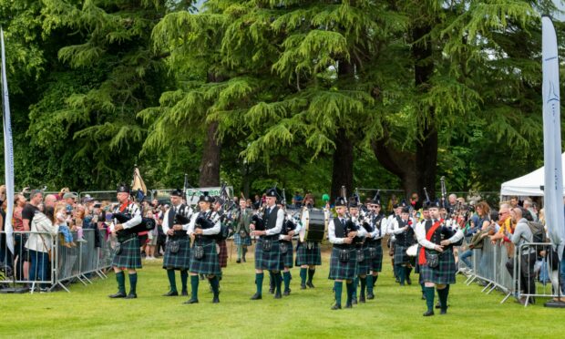 Forres Pipe Band lead the procession for the opening of the games. Photo: Jasperimage.
